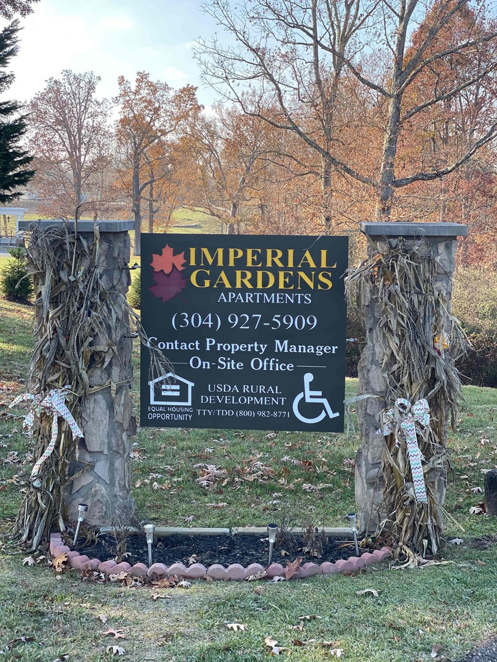 A sign for Imperial Gardens is displayed on a post.