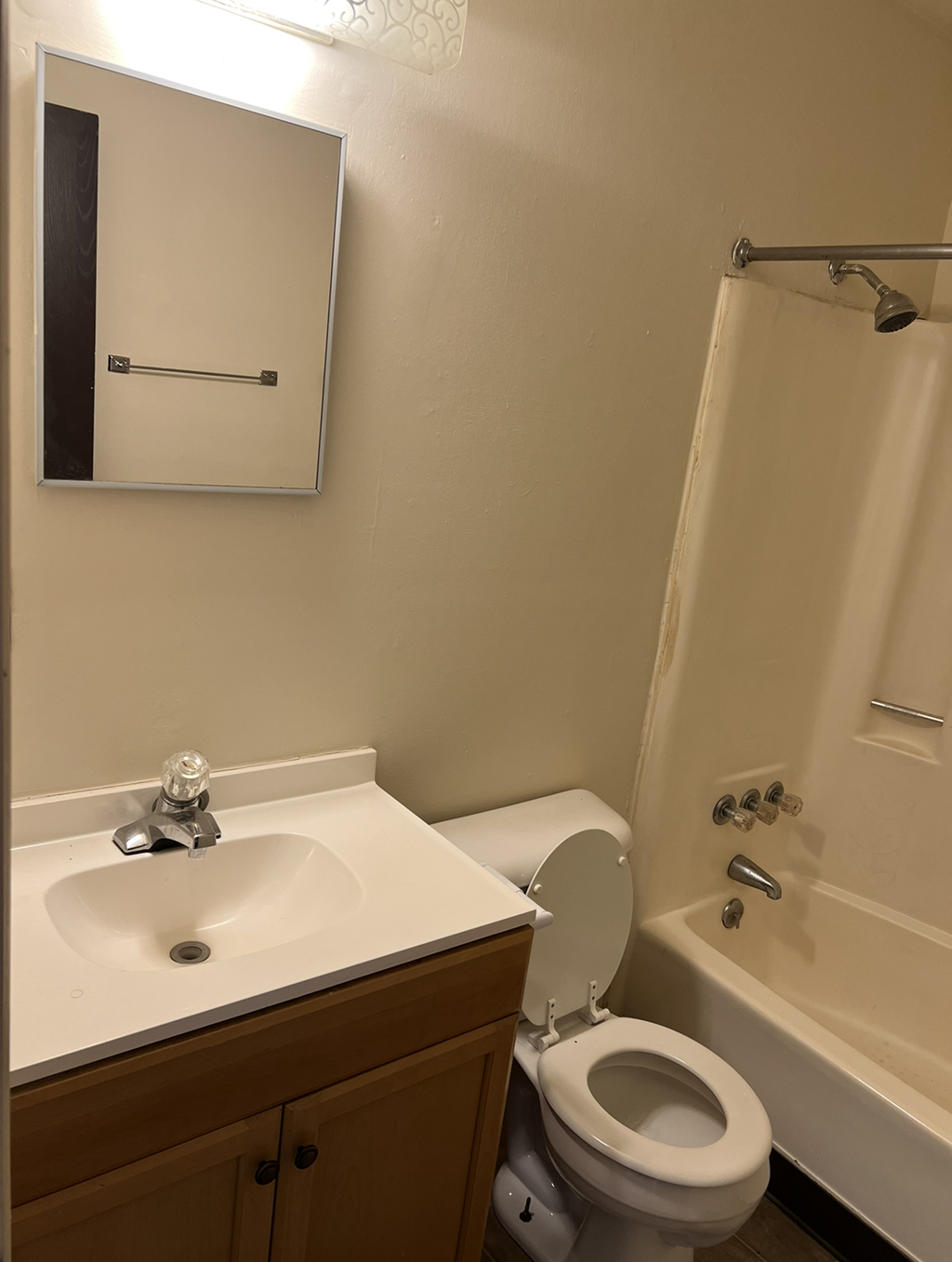 A white sink with a silver faucet in a bathroom.