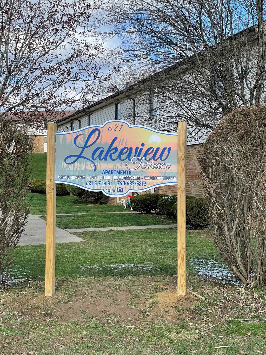 A sign for Lakeview Apartments is displayed in front of a building.