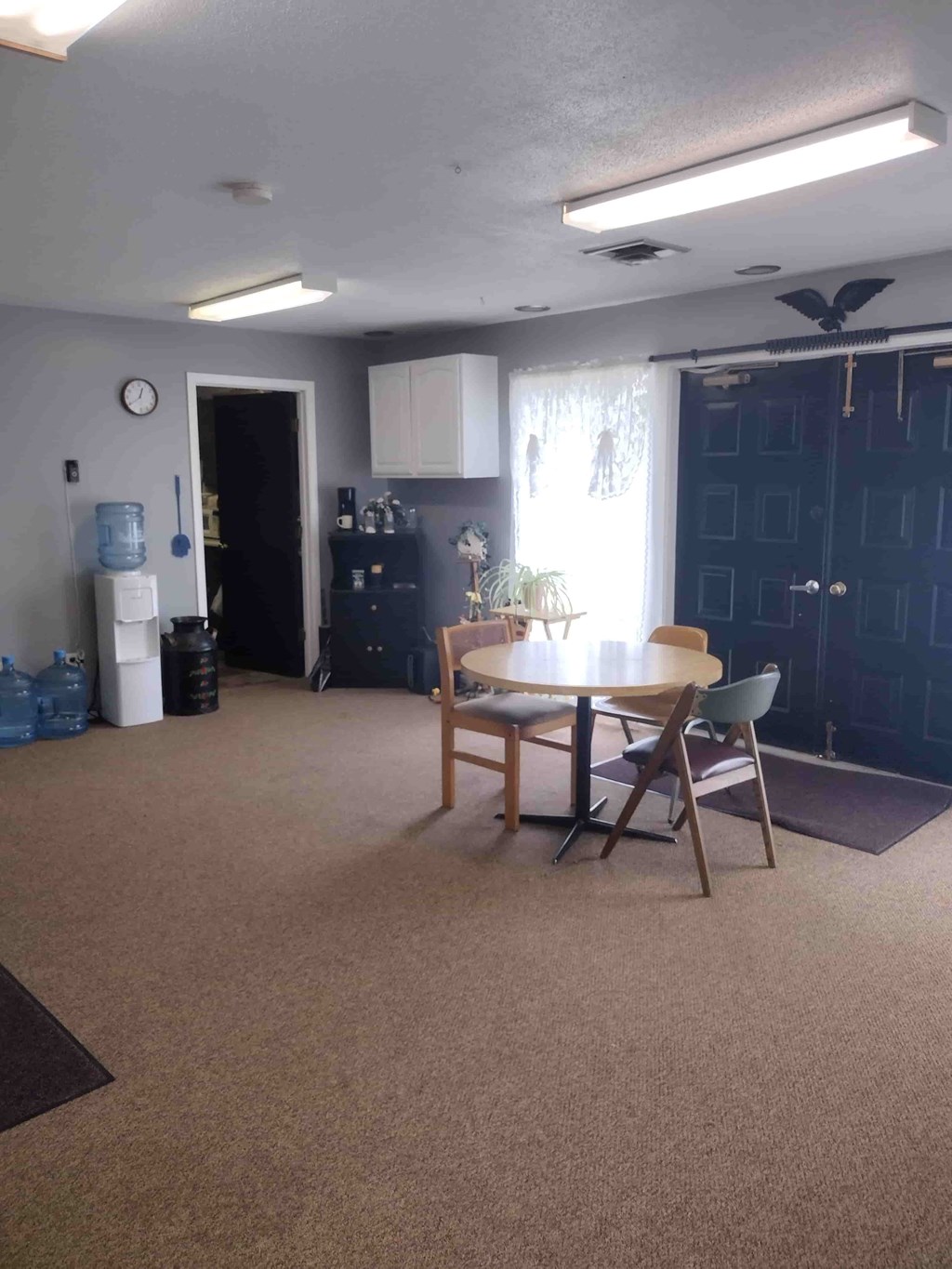 A kitchen with a dining table and chairs.