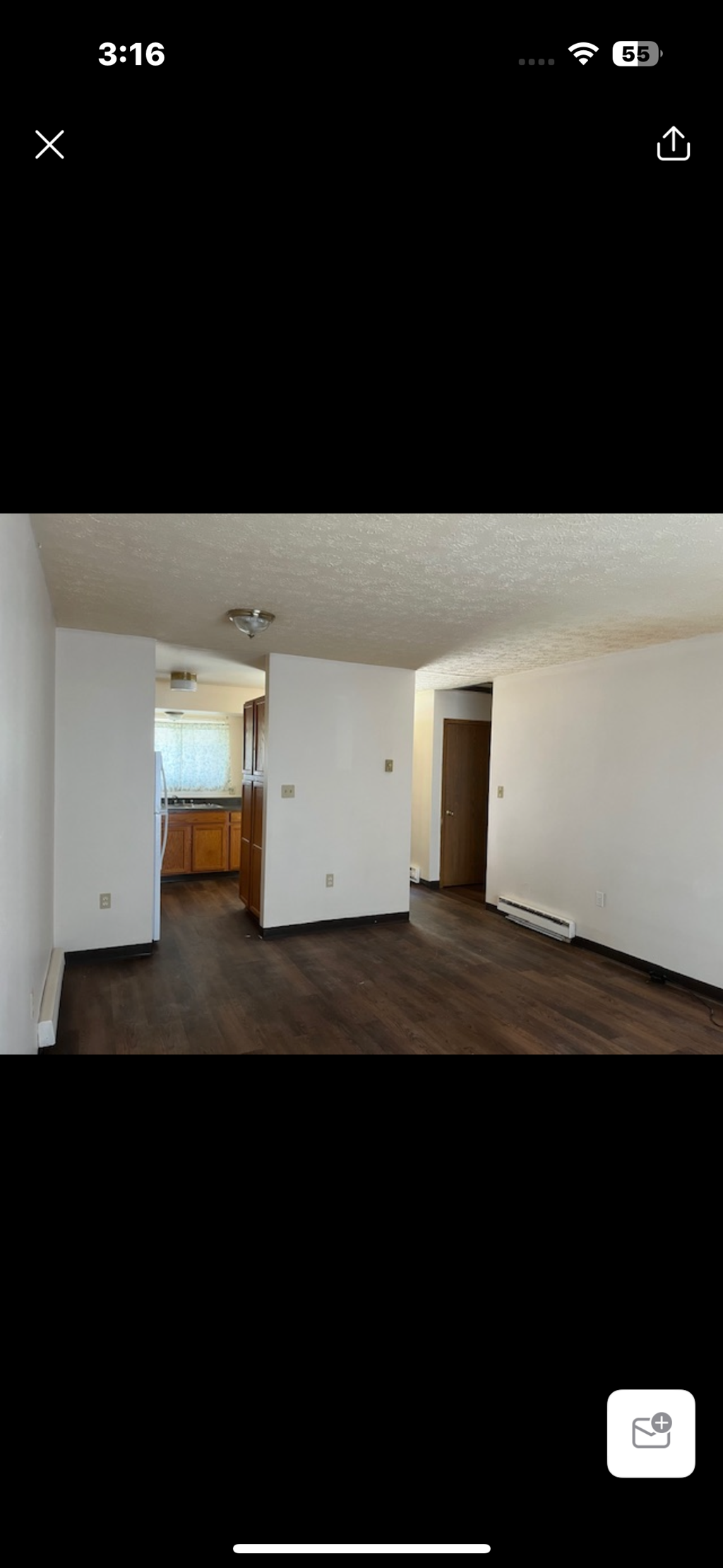 A room with a wooden door and a window.