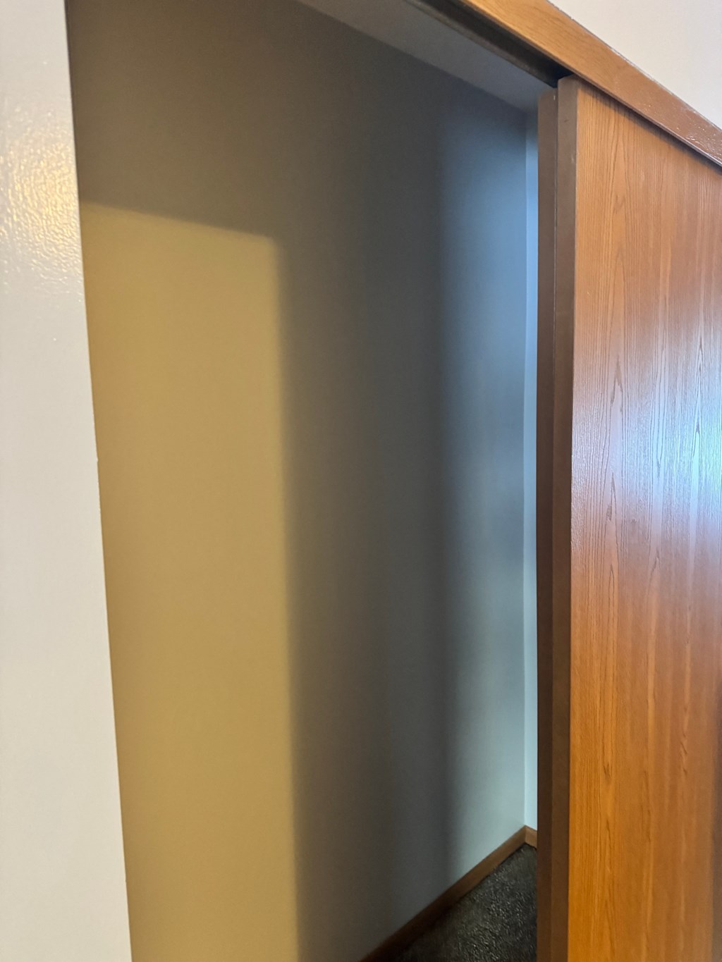 A wooden door with a glass panel in the middle.