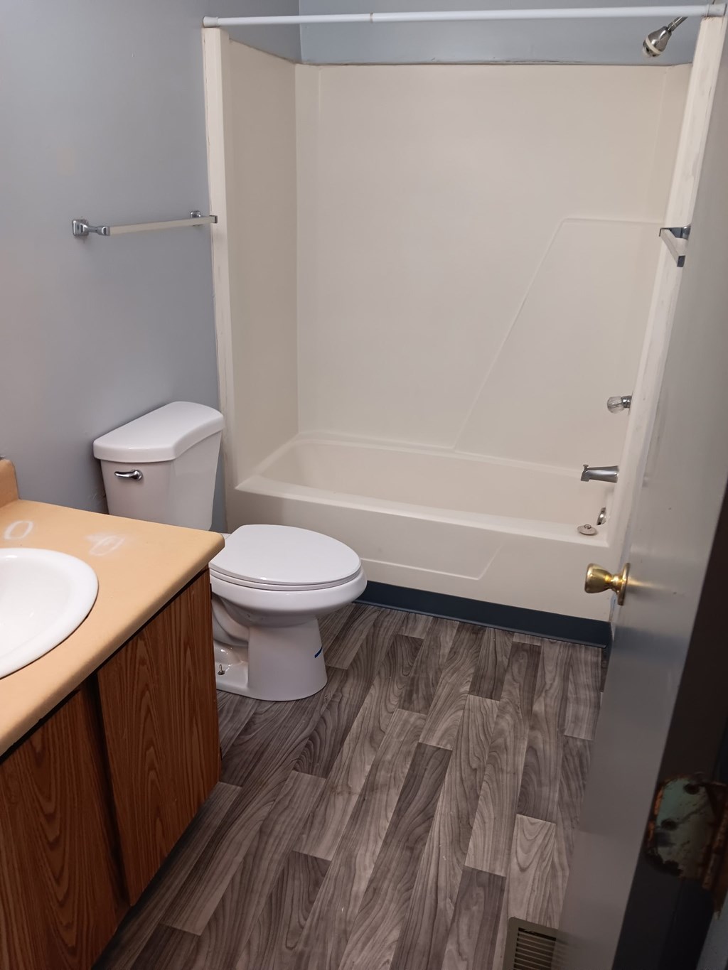 A white toilet sits next to a sink in a small bathroom.