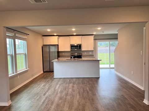 A kitchen with a white countertop and a refrigerator.
