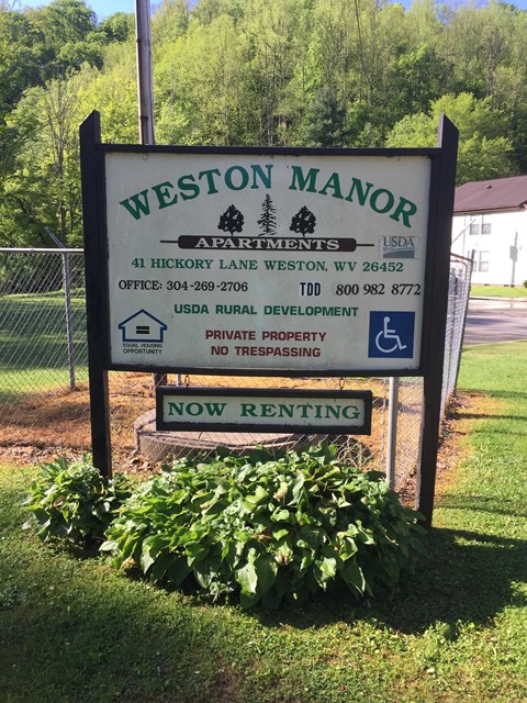 A sign for Weston Manor Apartments is now renting.