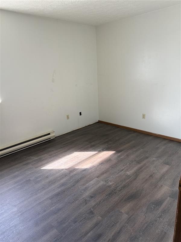 A room with a wooden floor and white walls.
