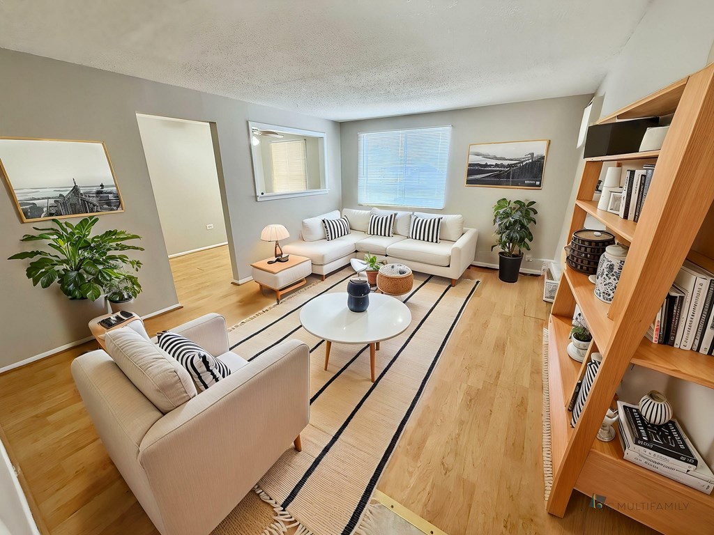 A living room with a white couch and a coffee table.