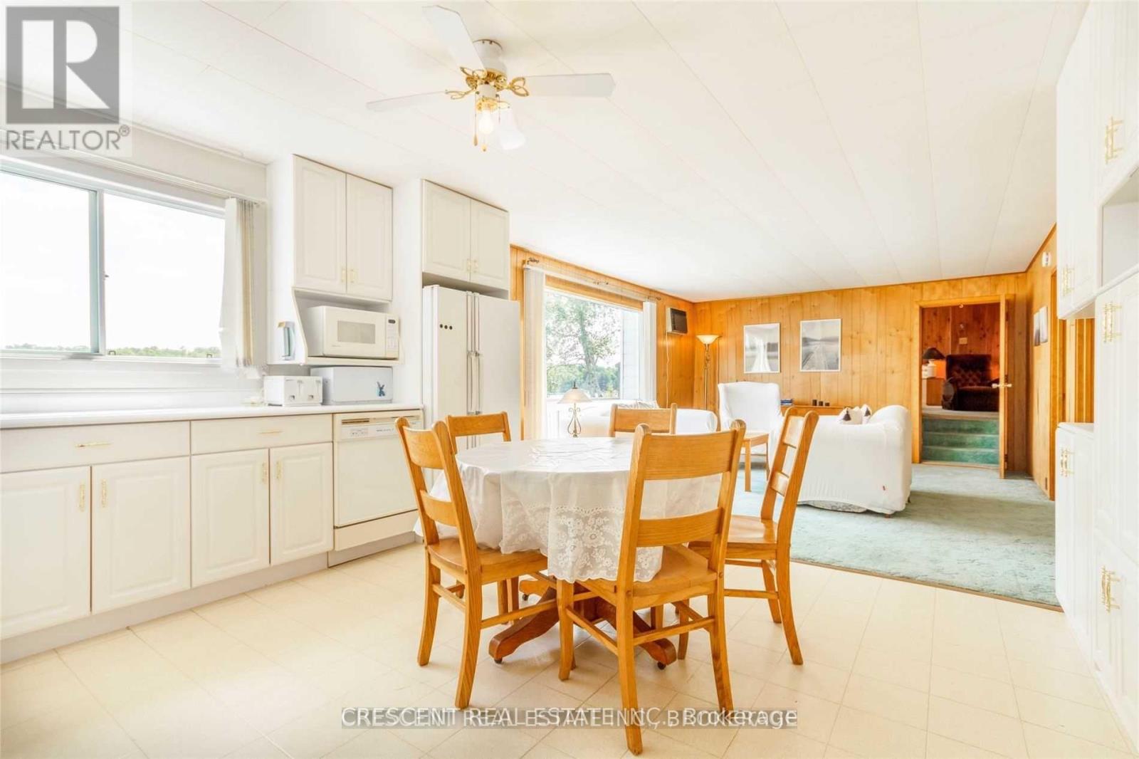 A dining room with a table set for four.