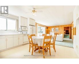 A dining room with a table set for four.