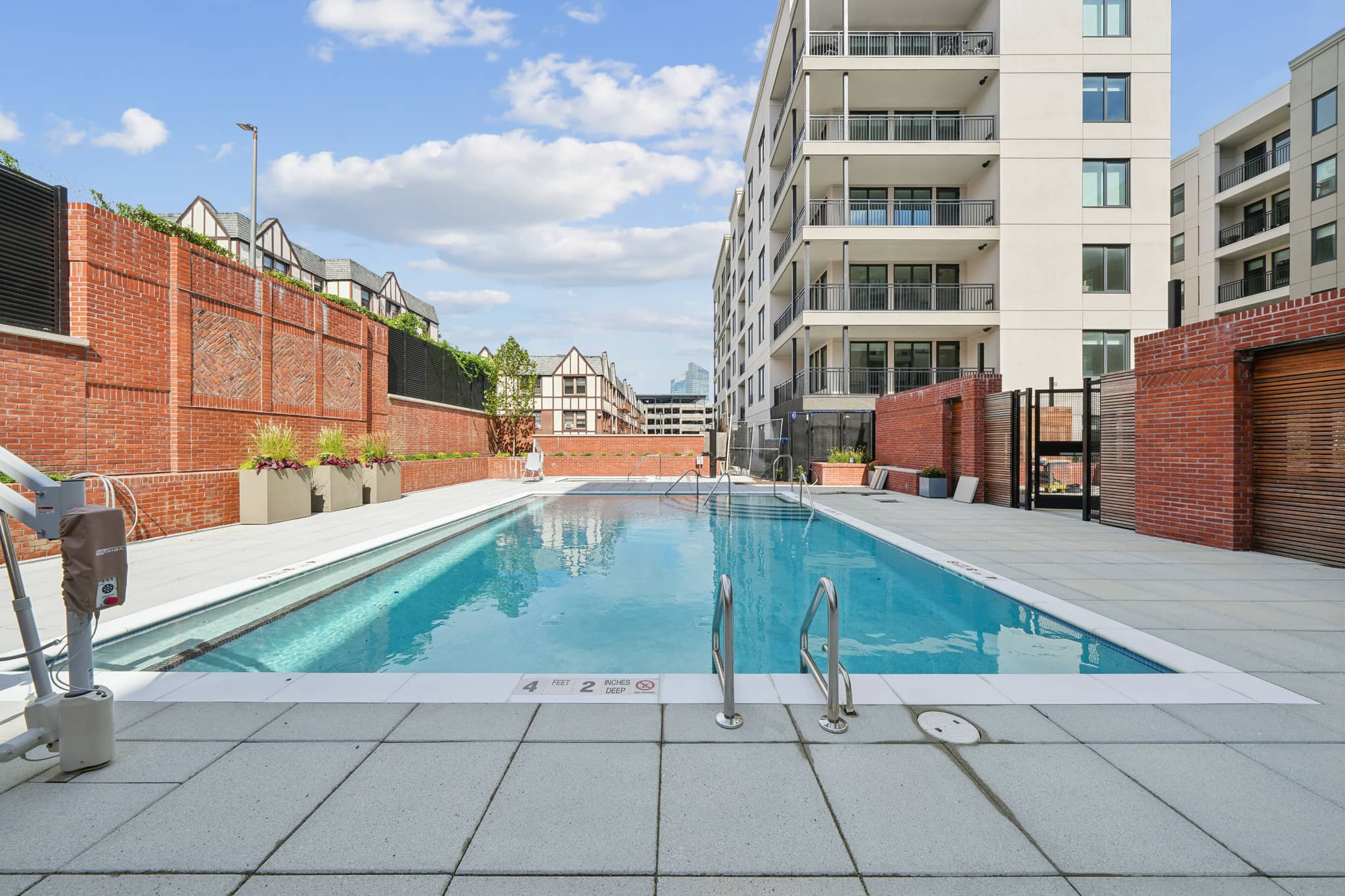 A rectangular pool with a metal ladder on the side.