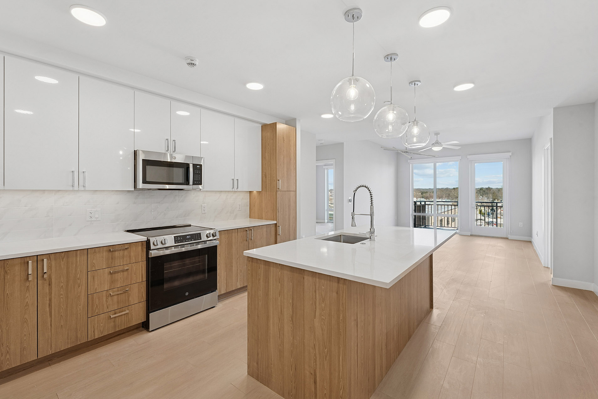 A modern kitchen with wooden cabinets and a white countertop.