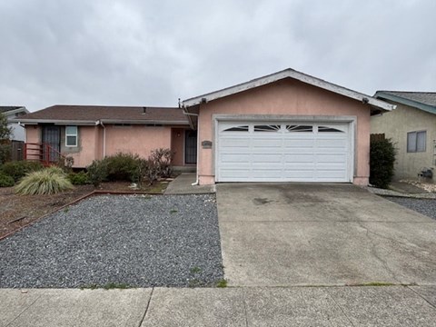 A house with a garage door in the front.