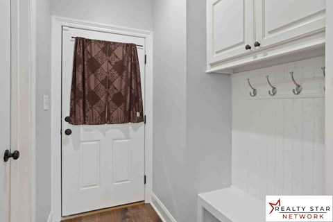 A white door with a brown curtain and a Realty Star Network logo.