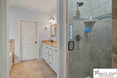 A bathroom with a shower and a sink.