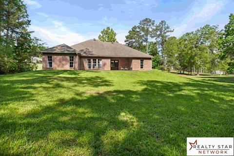 A house with a lawn in front of it.