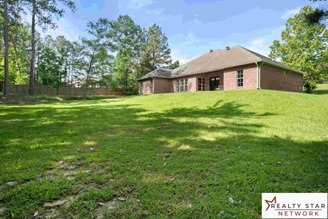 A house with a yard is for sale.