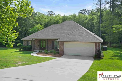 A house with a driveway in front of it.