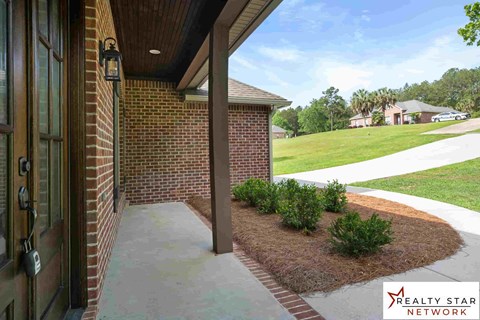 A house entrance with a Realty Star Network logo.