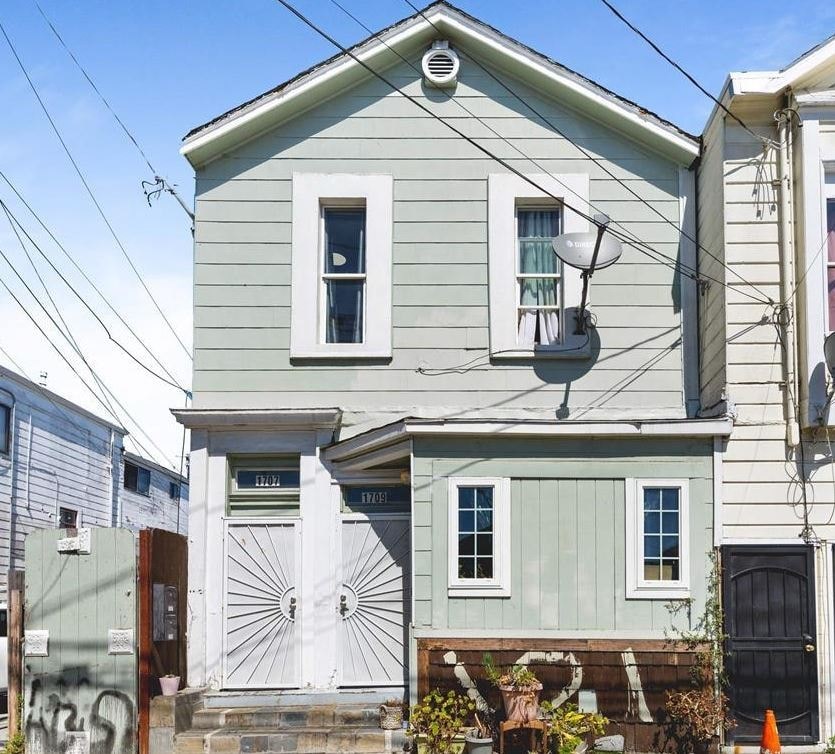 A house with a white door and a window with a white frame.