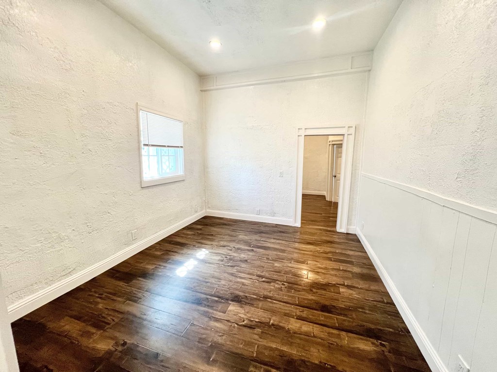 A room with wooden floors and white walls.