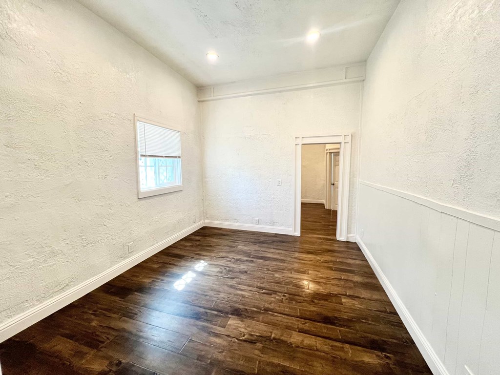 A room with wooden floors and white walls.