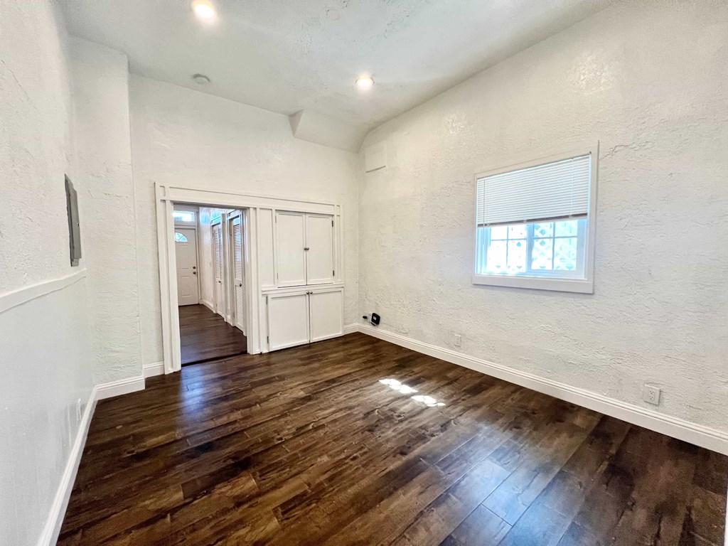 A room with wooden floors and white walls.