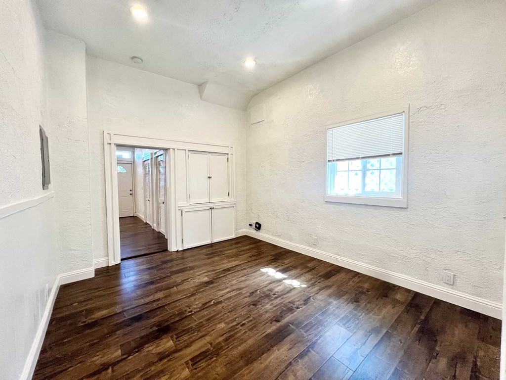 A room with wooden floors and white walls.