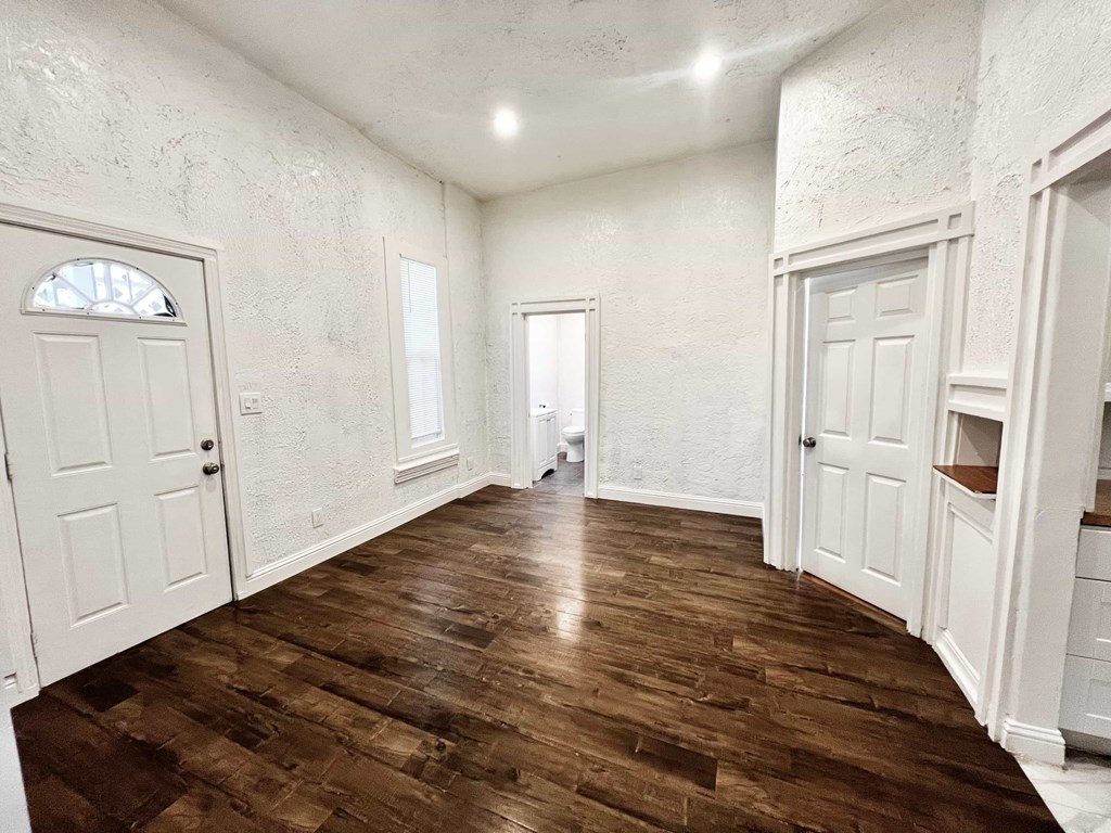 A room with wooden floors and white walls.