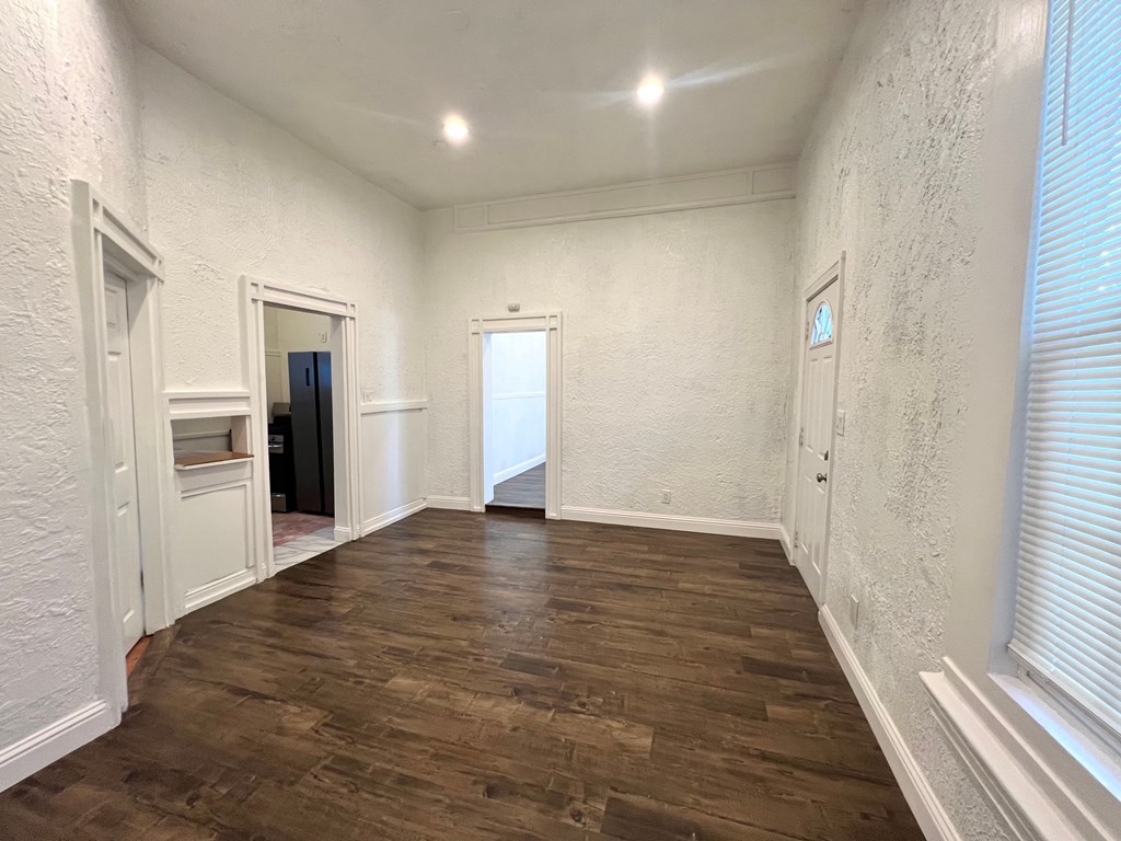 A room with wooden floors and white walls.