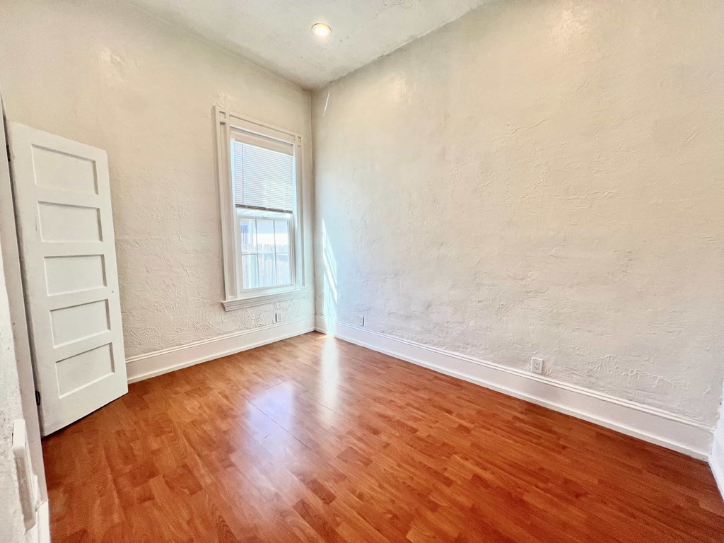A room with wooden floors and white walls.