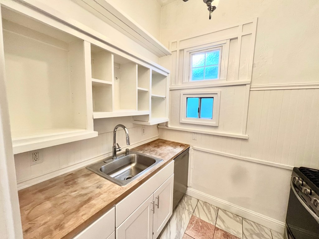 A kitchen with a sink and a window.