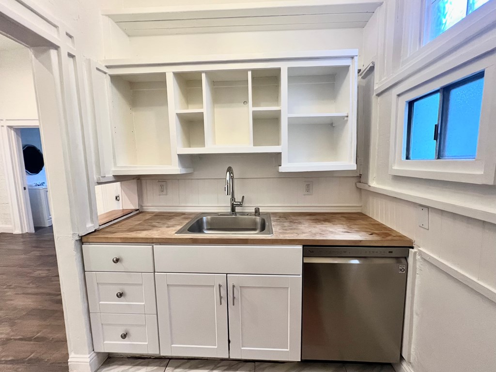 A kitchen with a sink and a window.