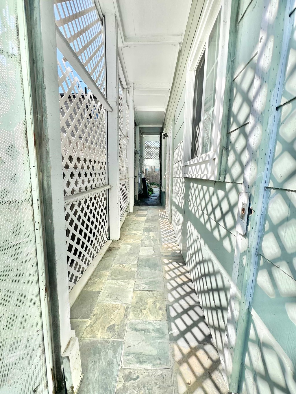 A long hallway with a patterned floor and walls.