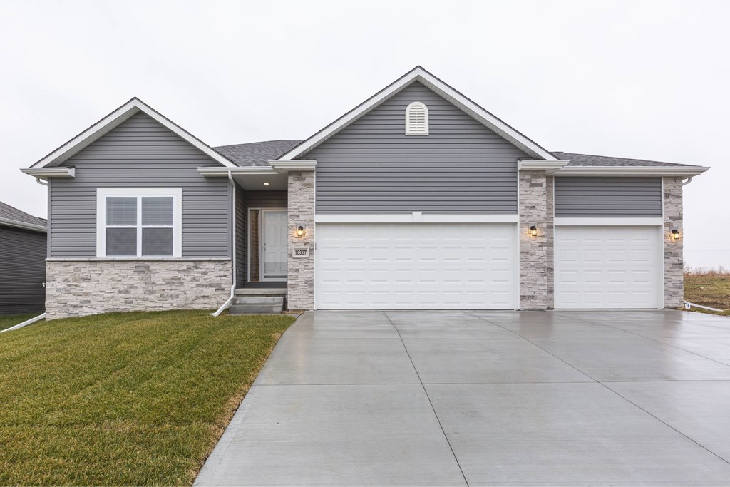 A grey house with a white garage door.