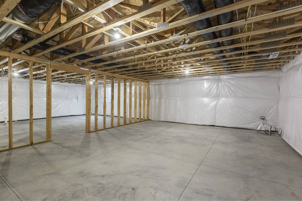 A room under construction with wooden beams and insulation.