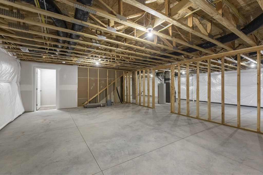A room under construction with wooden beams and unfinished walls.