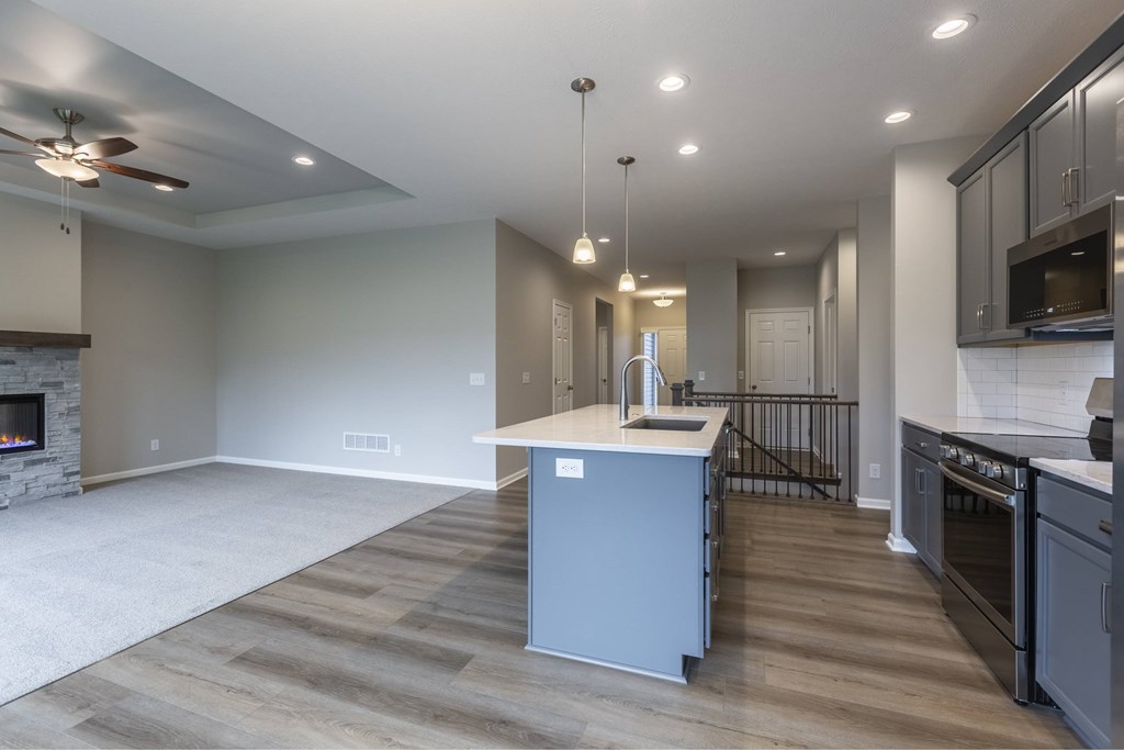A modern kitchen with a large island and stainless steel appliances.