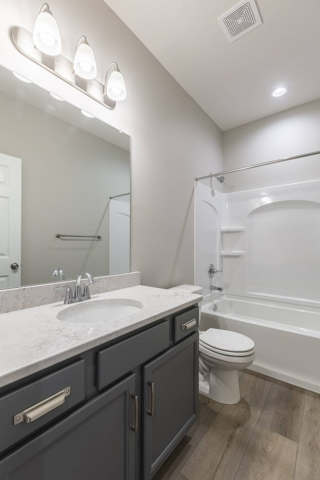 A bathroom with a sink, toilet, and bathtub.