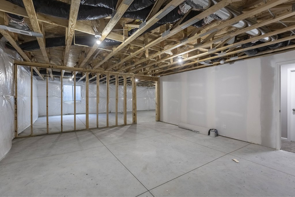 A room under construction with wooden beams and no walls.