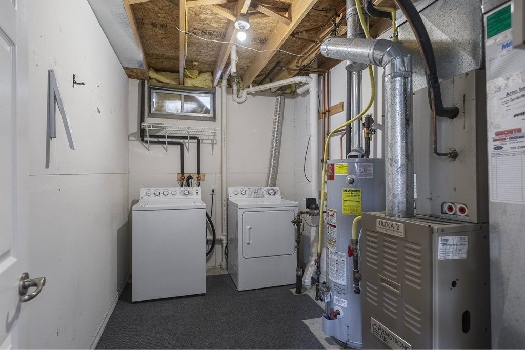 A utility room with a washer and dryer, a furnace, and a water heater.
