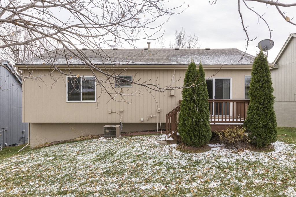 A house with a brown roof and a white fence.