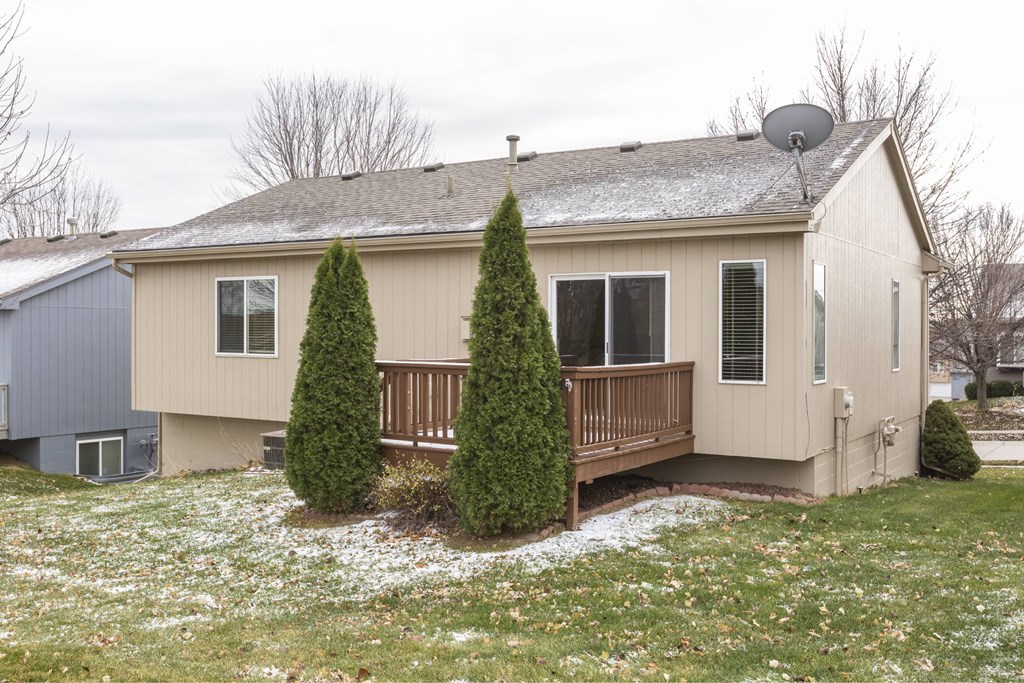 A house with a grey roof and a brown fence.