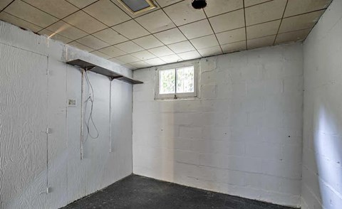 A white bathroom with a window and a shower.