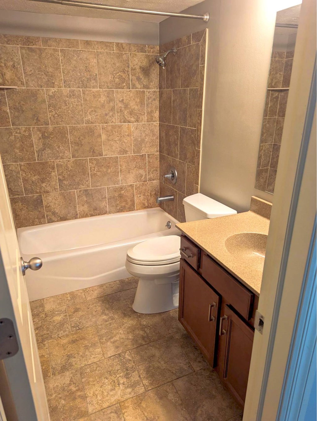 A bathroom with a toilet, sink, and bathtub.