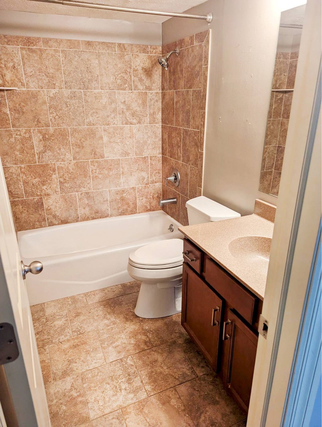 A bathroom with a toilet, sink, and bathtub.