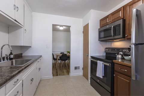 A kitchen with a black oven and a black microwave.