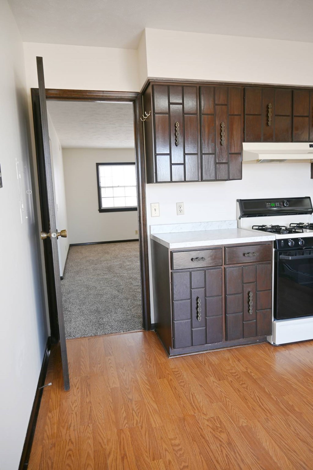 A kitchen with a black stove top oven.