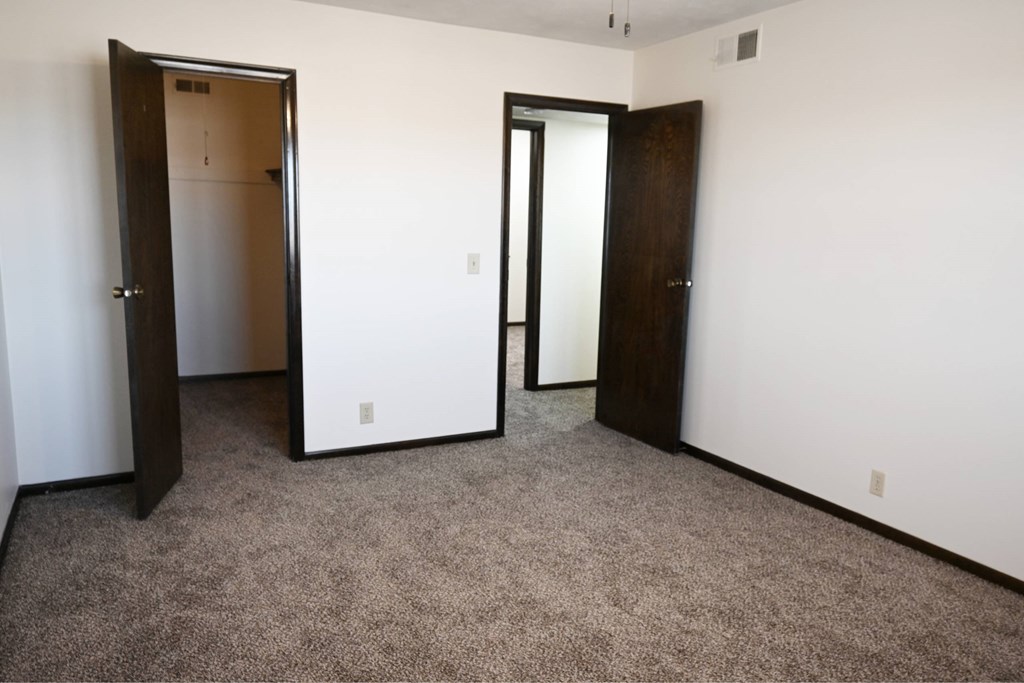 A room with two doors, one of which is open.