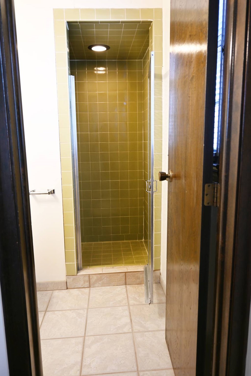 A glass elevator with a metallic door.