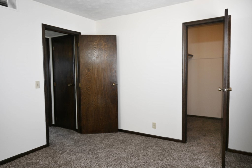 A room with a brown door and a white door.